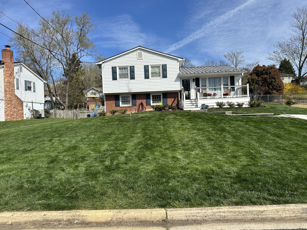 Suburban house with green lawn.